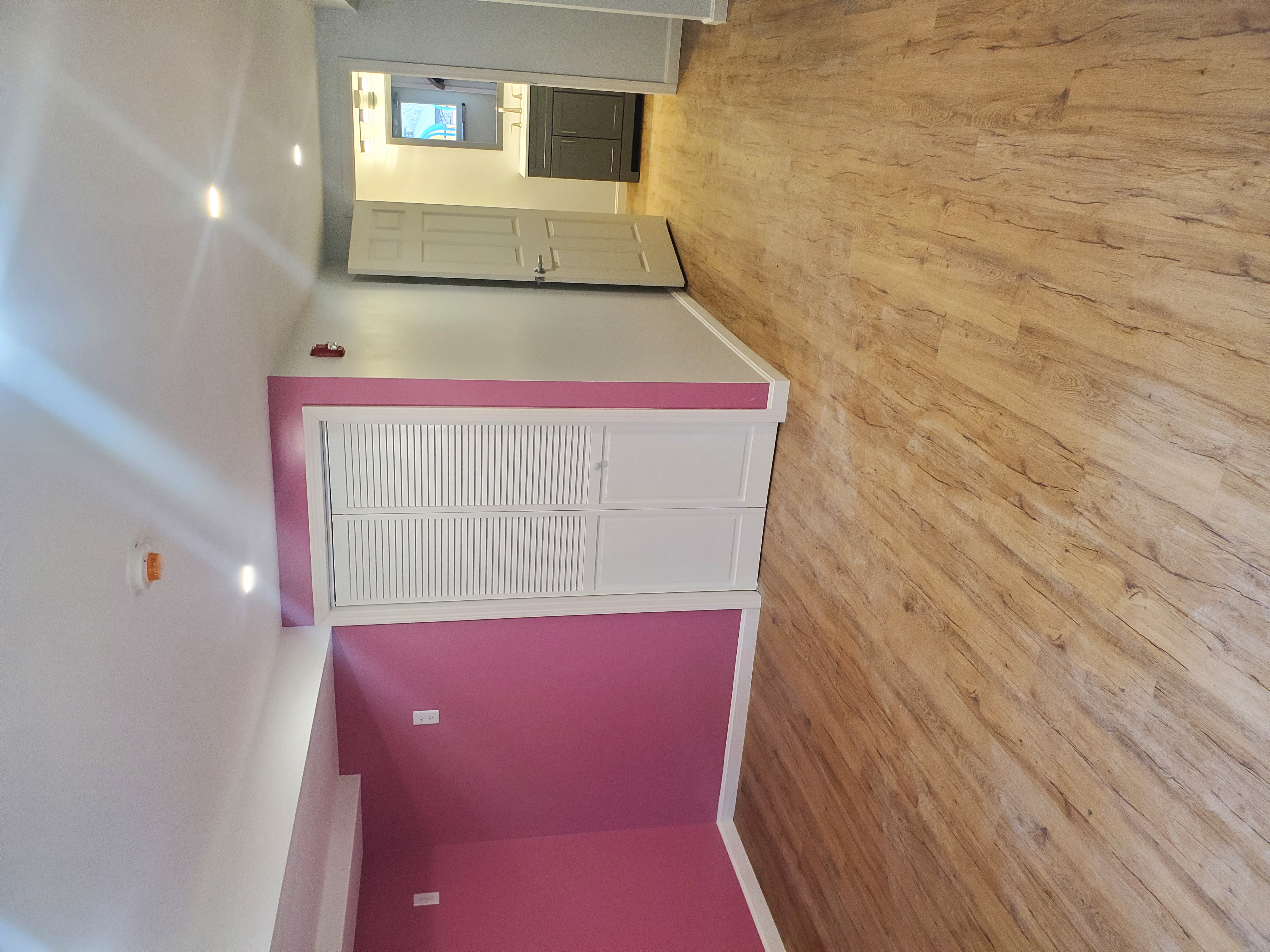 Finished basement living space with quality flooring and professional lighting installation