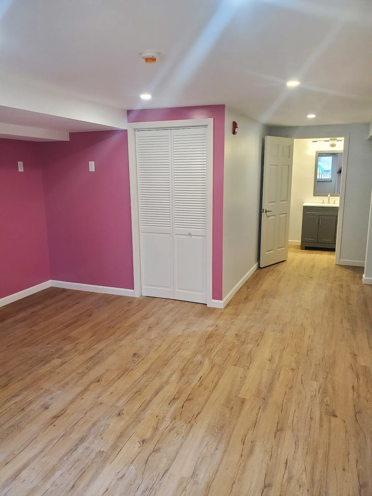 Finished basement with quality flooring and professional lighting installation
