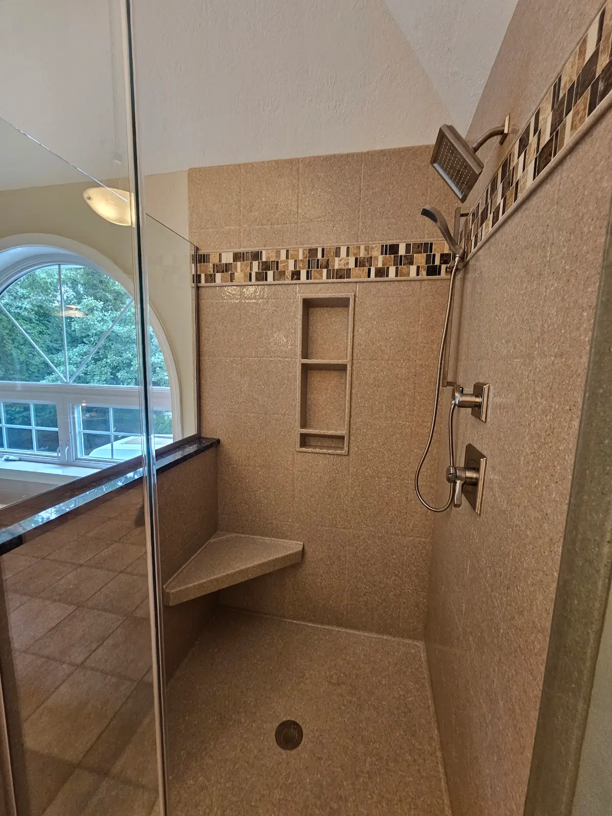 Custom corner shower replacement featuring solid corian shower walls