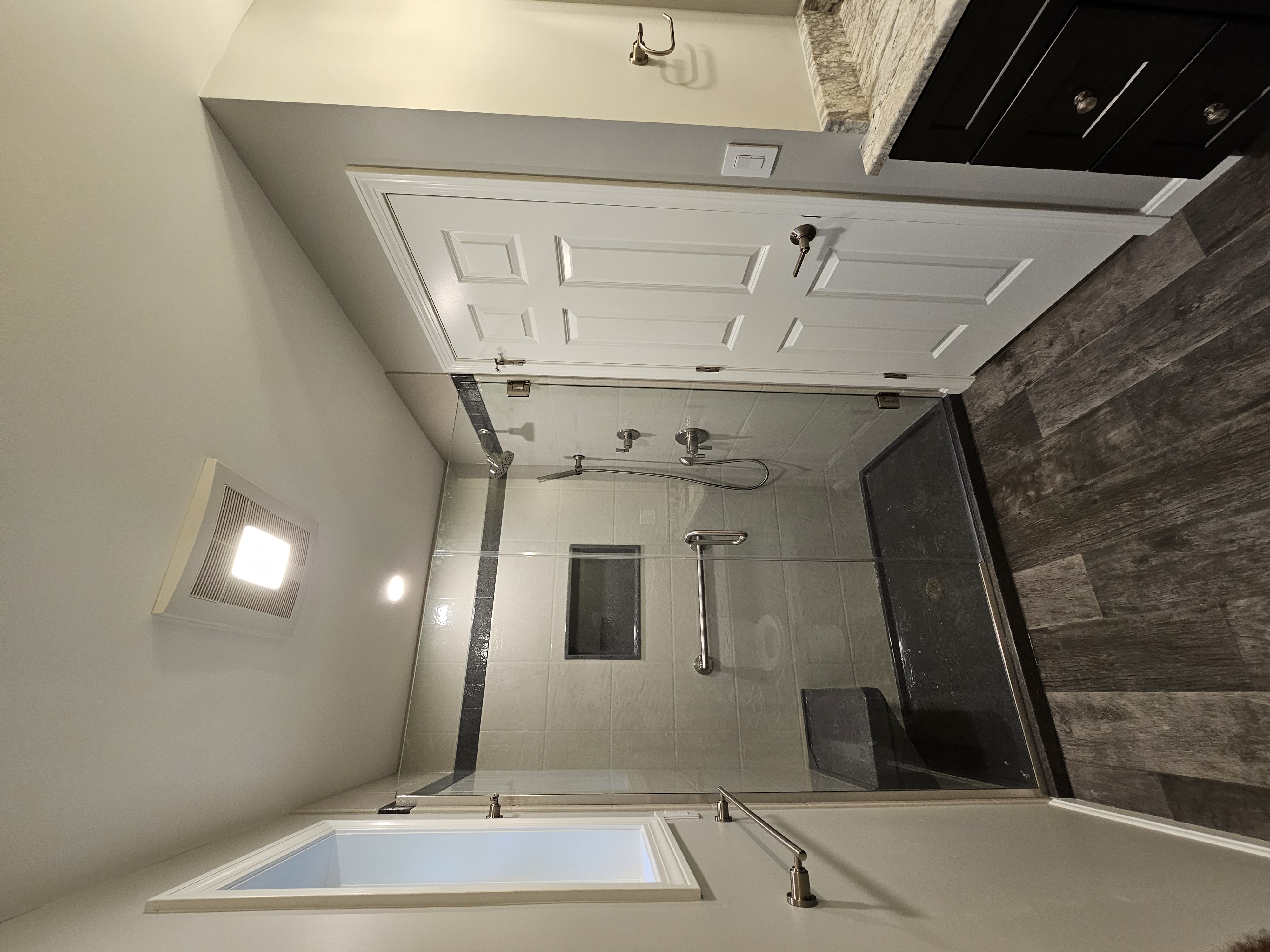 Contemporary bathroom with custom vanity and modern tile work